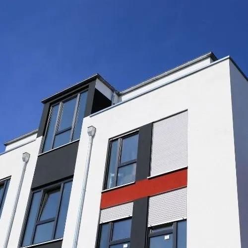 This is a picture of the outside of a block of flats that have been externally painted in white paint by Painters and decorators Leicester